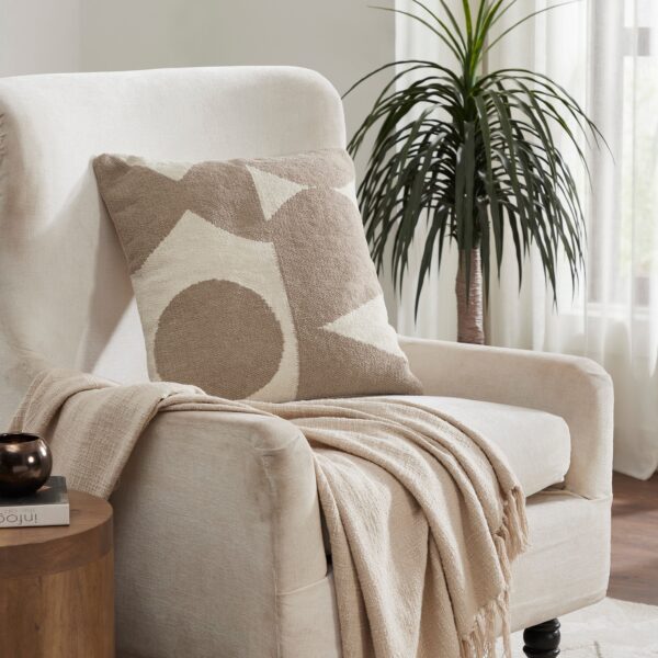 Renwil Ferla Beige and Cream Handwoven Poly-Chenille Pillow 20 x 20 PWFL1468 - pillow styled on an armchair