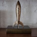 Renwil Brooks Rocket Sculpture — styled on a decorative book
