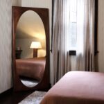 Renwil Sitia Walnut Finish Pine Full Length Mirror MT2698 - full length mirror styled leaning in a bedroom