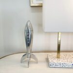 Renwil Rush Decorative Sculpture STA432 — silver rocket sculpture styled on a console